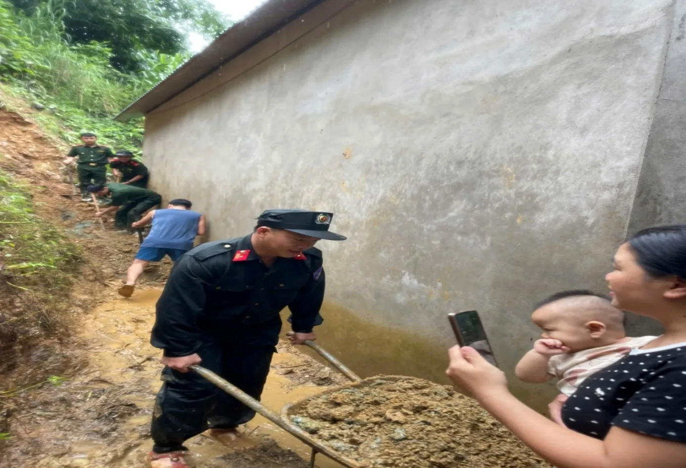 Gia đình chị Lý Thị Chớn xúc động khi được Cán bộ chiến sĩ Phân trại tạm giam Mường Tè giúp di chuyển khối lượng lớn đất đá ra khỏi điểm sạt lỡ sau nhà